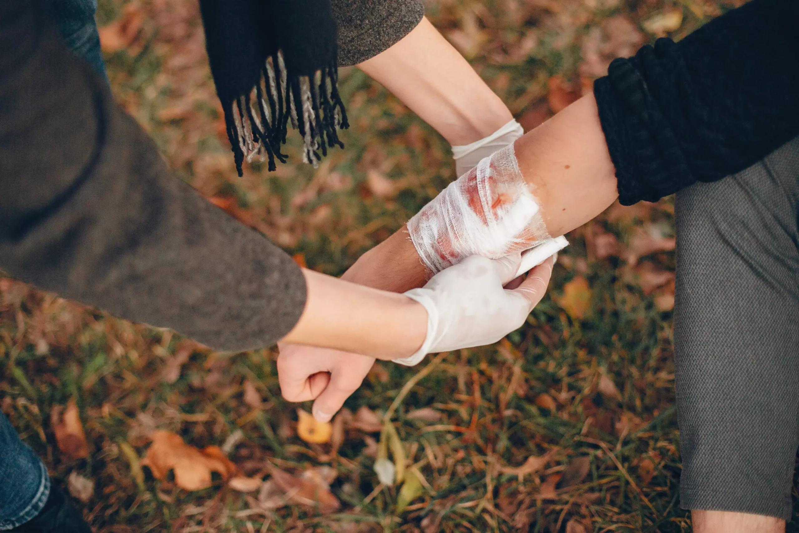 Woman applying a bandage on a wound