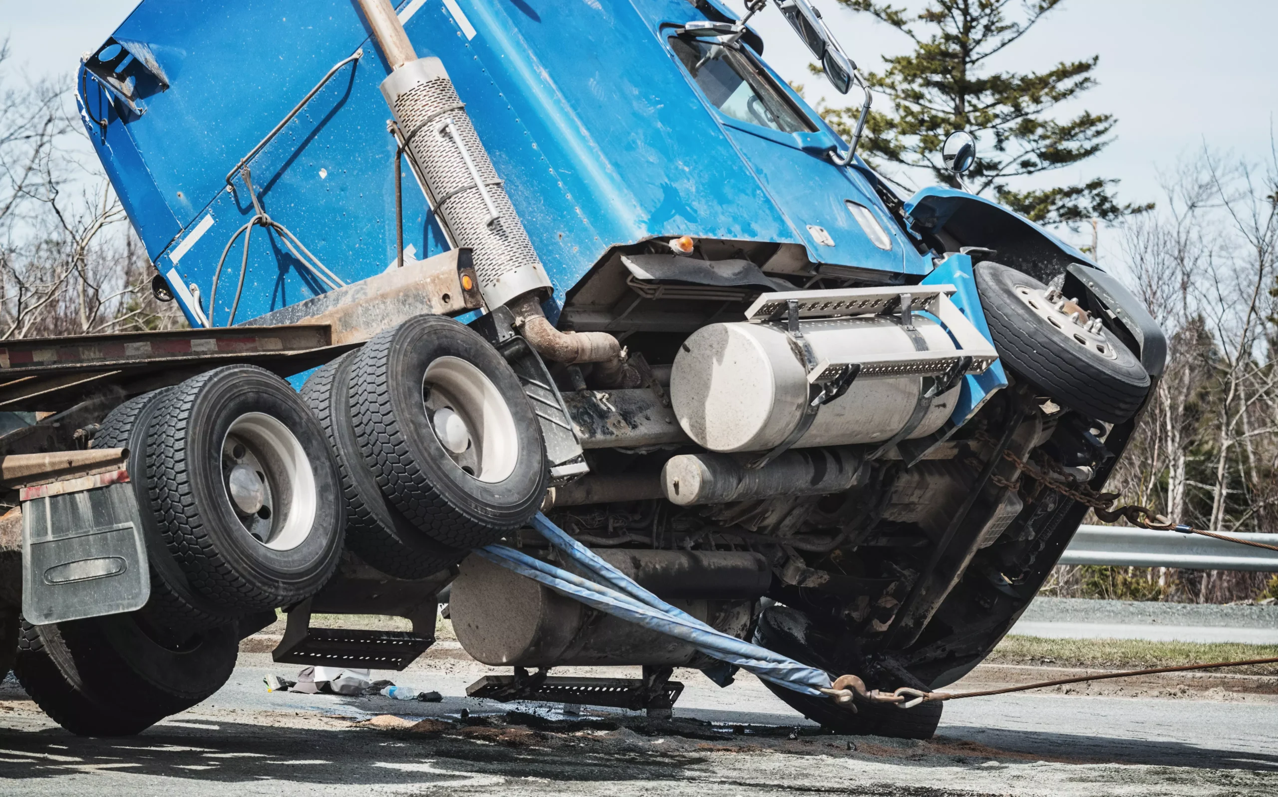 Blue truck damaged and tilted