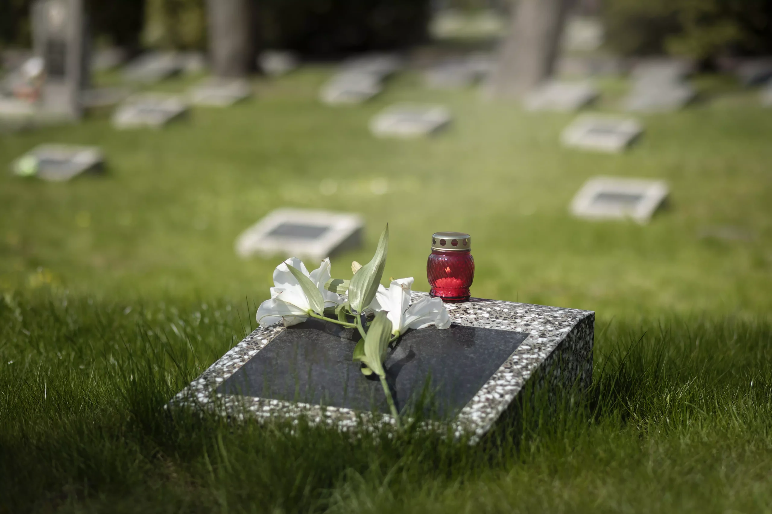 Grave stone with flower and candle