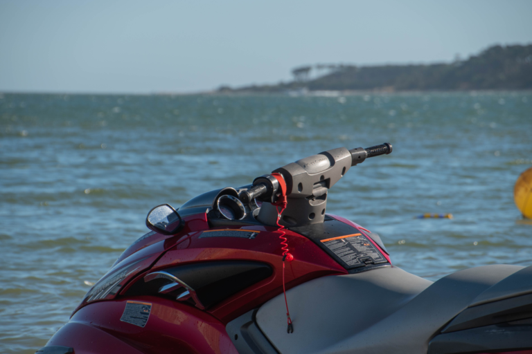 A red jet ski parked on a beach
